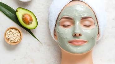 A woman with a face mask with an avocado