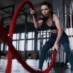 Woman using battle ropes