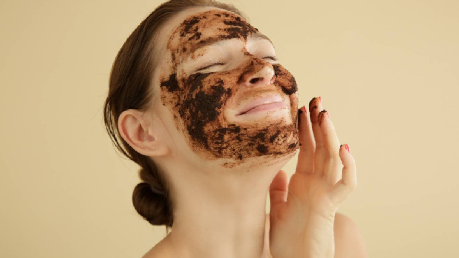 Women applying coffee face scrub