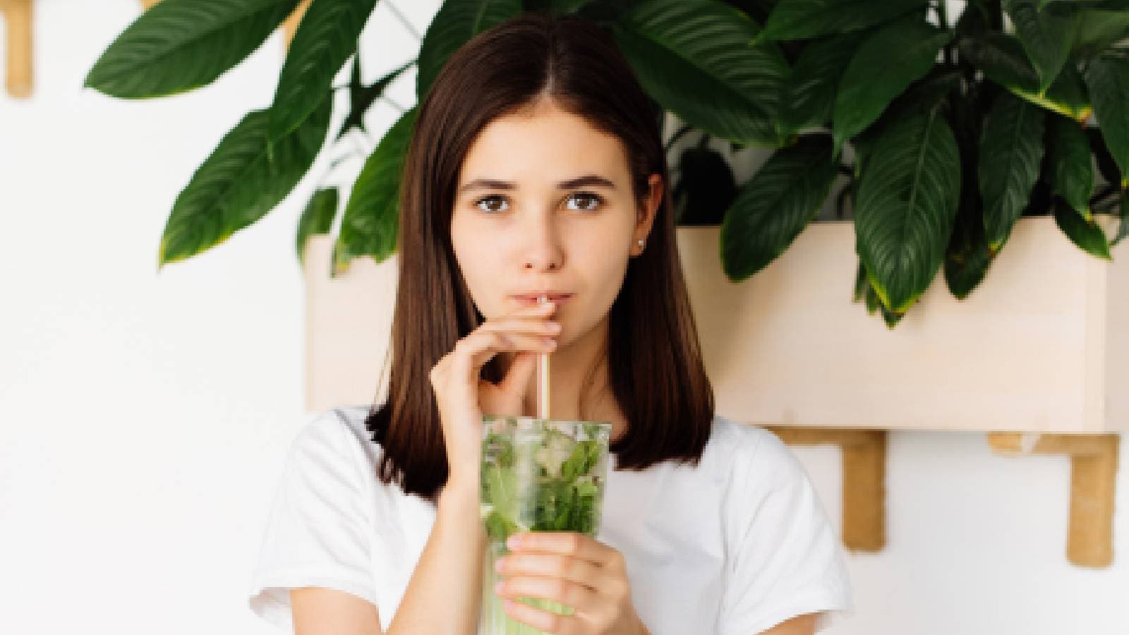 A woman drinking detox water