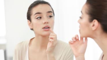 A woman exfoliating lips