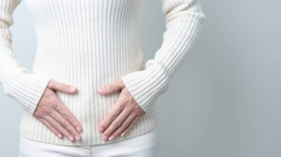 A woman with her hands on her belly