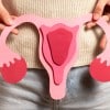 Woman holds a uterus model to indicate healthy period