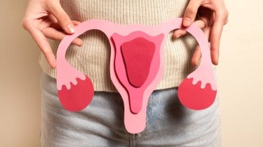 Woman holds a uterus model to indicate healthy period