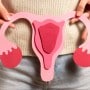 Woman holds a uterus model to indicate healthy period